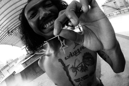 Professional_Skateboarder_smiling_holding_the_Rockstar_Pendant_at_skatepark