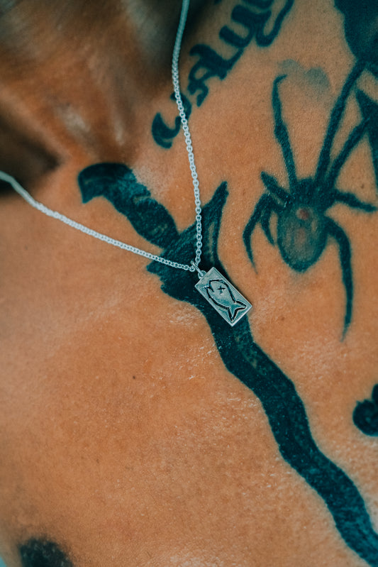 Lifestyle Shot of "Badfish Dogtag Pendant" on Sterlling Silver Chain