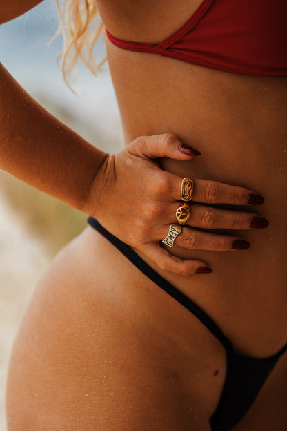Mixed Metal Rings on Model in Bikini, modeling the lifestyle of Badfish jewelry. Also wearing the "Badfish Ring" and "Teach Peace Ring"