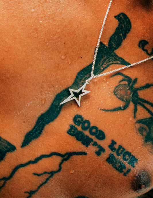 Lifestyle shot of Rockstar Sterling Silver Pendant on Tattooed man